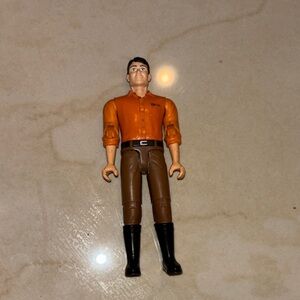 Action Figure with Orange Shirt and Brown Pants